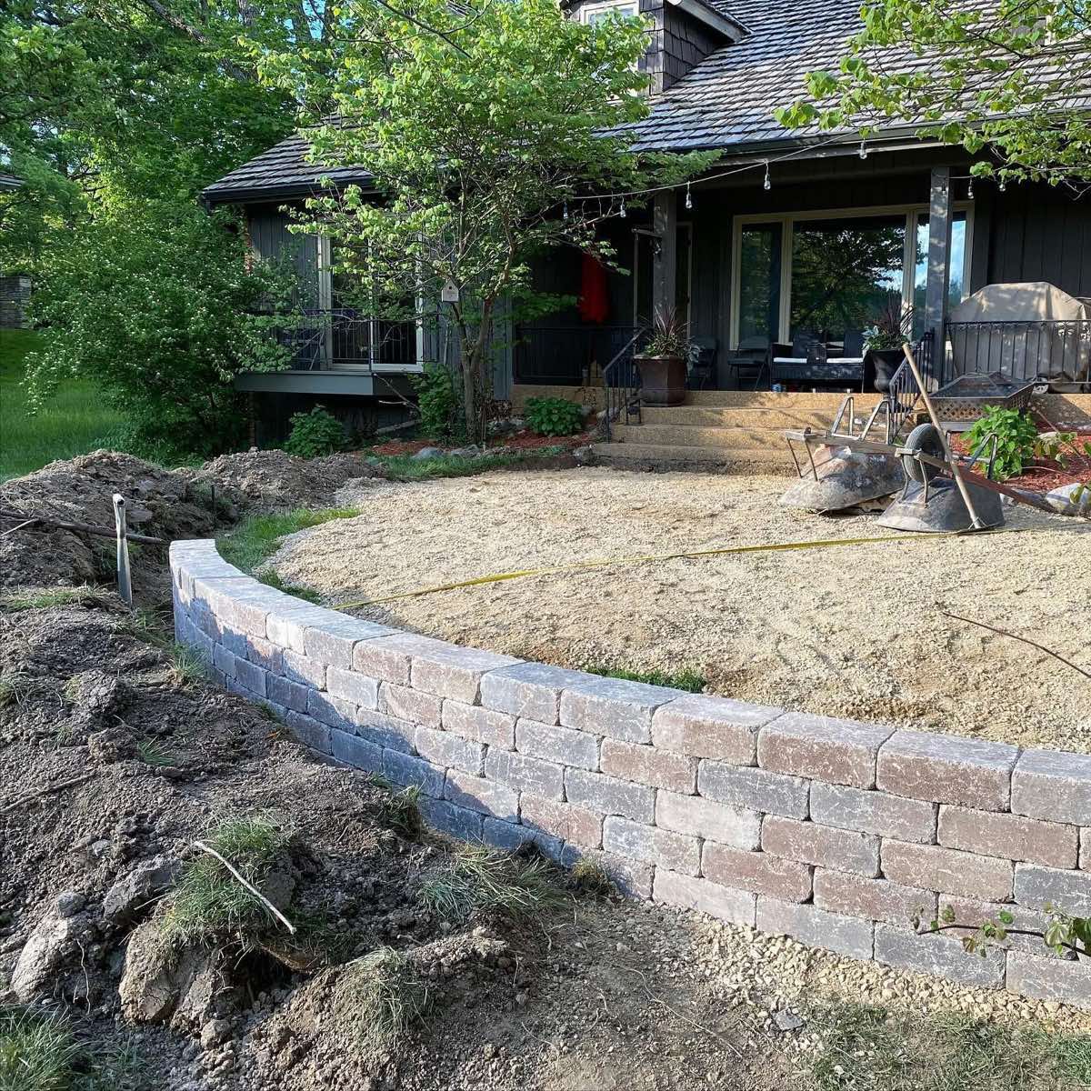 Curved block retaining wall built and backfilled during construction