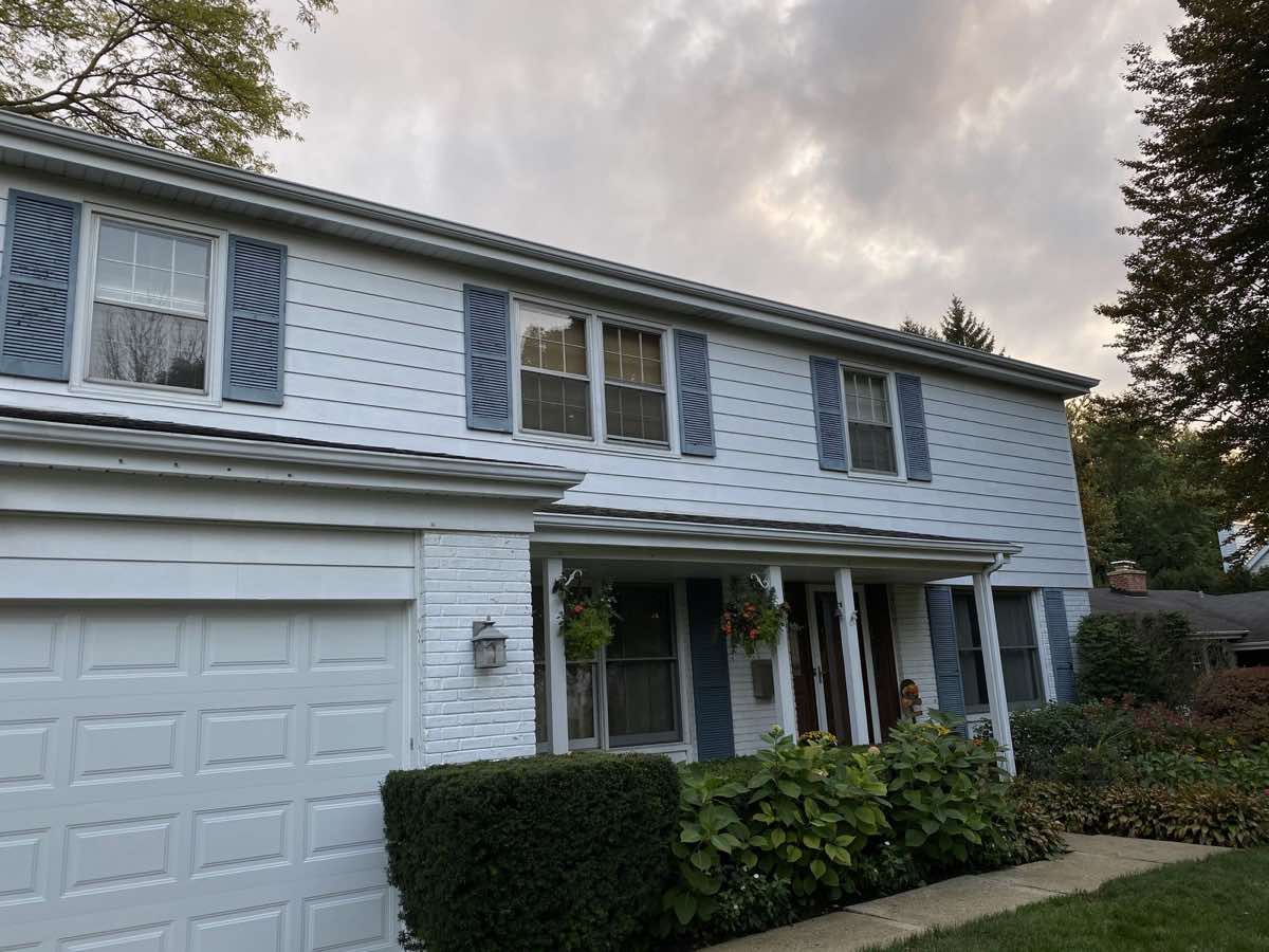 After — uniformly clean white siding