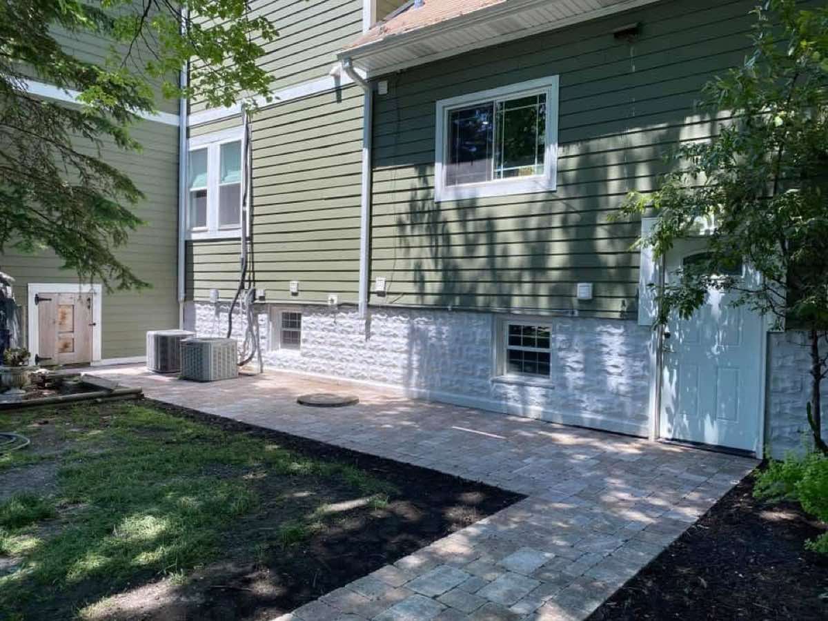 Paver side patio and walkway installed along the foundation