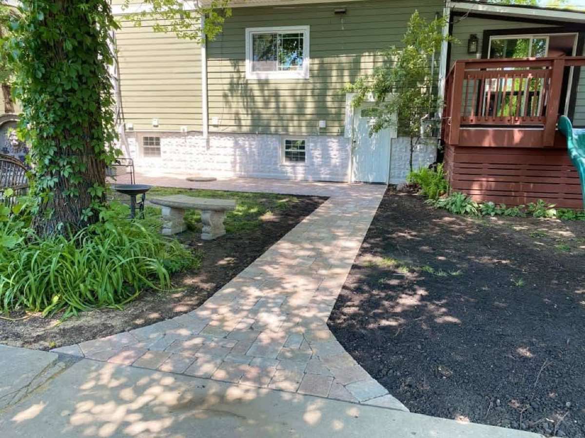 New paver walkway through freshly prepared planting beds